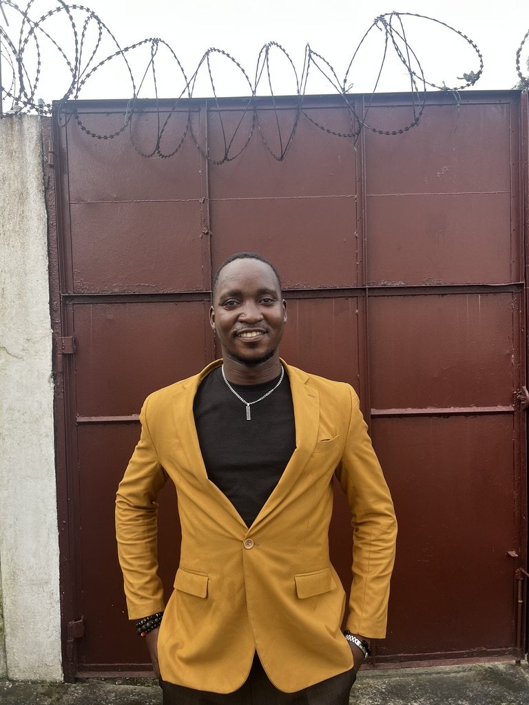 Emmanuel in a yellow blazer outdoors
